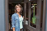 Woman standing in doorway of shop