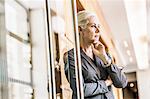 Businesswoman arms crossed hand on chin looking away