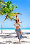 Happy young woman dancing on beach, Dominican Republic, The Caribbean