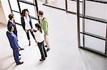 High angle view of businessmen and women having discussion at office entrance