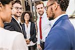 Businessmen and businesswomen having discussion outside office