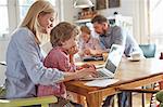 Parents and sons working in home office