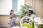 Couple talking and drinking mint tea on hotel room  balcony, Dubai, United Arab Emirates