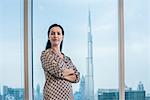 Portrait of businesswoman at window, Dubai, United Arab Emirates