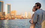 Romantic couple looking out at Dubai marina, United Arab Emirates