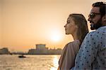 Romantic couple watching sunset at Dubai marina, United Arab Emirates