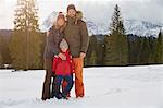 Portrait of parents and son in snow covered landscape, Elmau, Bavaria, Germany