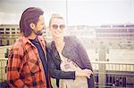 Portrait of cool mid adult couple on rooftop parking lot