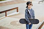 Boy skateboard looking at camera smiling
