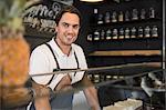 Happy restaurateur behind service counter