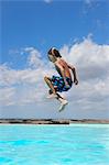 Boy jumping into swimming pool, Buonconvento, Tuscany, Italy