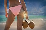 Waist down rear view of young woman wearing bikini bottom   on Miami beach, Florida, USA