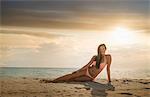 Portrait of young woman wearing bikini relaxing on Miami beach, Florida, USA