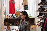 Businesswoman working at laptop in vintage shop