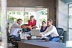 Designers meeting at conference table in design office