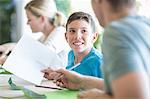 Father and son sitting together, father helping son with homework