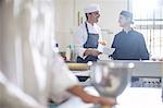 Chefs chatting in kitchen