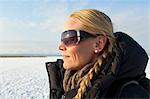 Sweden, Ostergotland, Smiling woman wearing sunglasses looking away