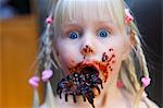 Sweden, Portrait of girl (4-5) eating messy candy