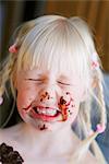 Sweden, Portrait of girl (4-5) with face dabbed with chocolate