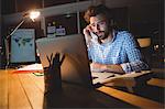 Businessman making a phone call at night