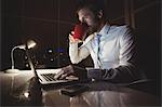 Businessman drinking coffee at night