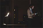 Businessman using tablet at night