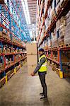 Warehouse worker carrying boxes