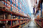 Man worker putting a box on a rack