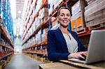 Low angle view of warehouse manager using her laptop