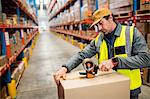 Man worker taping up a box