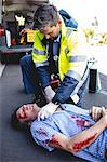 Ambulanceman healing injured man