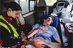 Injured man with ambulancewoman