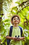 Happy boy holding binoculars