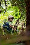 Boy examining the plants with magnifying glass