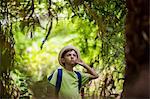 Boy standing in forest