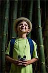 Boy standing in forest