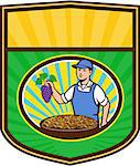 Illustration of an organic farmer boy wearing hat holding grapes with a bowl of raisins in front of him viewed from front set inside shield crest with sunburst in the background done in retro style.