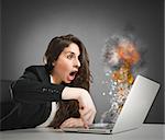 Astonished woman looks at the computer inflamed