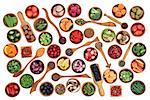 Health and super food of fruit, nuts, seeds and vegetables in wooden bowls and spoons over white background, high in vitamins, antioxidants, anthocyanins and minerals.