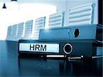 HRM - Illustration. Hrm. Illustration on Blurred Background. HRM - File Folder on Working Desktop. HRM - Business Concept on Blurred Background. 3D Render.