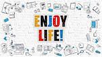 Enjoy Life. Multicolor Inscription on White Brick Wall with Doodle Icons Around. Enjoy Life Concept. Modern Style Illustration with Doodle Design Icons. Enjoy Life on White Brickwall Background.