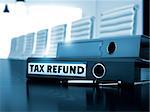Tax Refund. Concept on Toned Background. Tax Refund - Business Concept. Binder with Inscription Tax Refund on Black Office Desk. 3D.