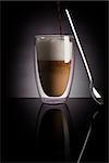 Caffe latte on dark background. Culinary coffee drinking.