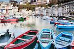 Canoes docked at urban harbor