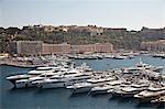 Boats docked in urban harbor