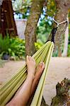 Close up of female legs and feet in beach hammock, Koh Lipe, Thailand