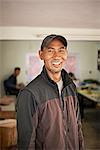 Portrait of male sewing factory worker, Thamel, Kathmandu, Nepal