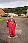 Norway, Brumunddal, Mjosa Camping, Boy (2-3) playing in puddle