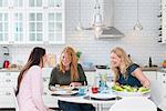 Sweden, Three laughing women at kitchen table